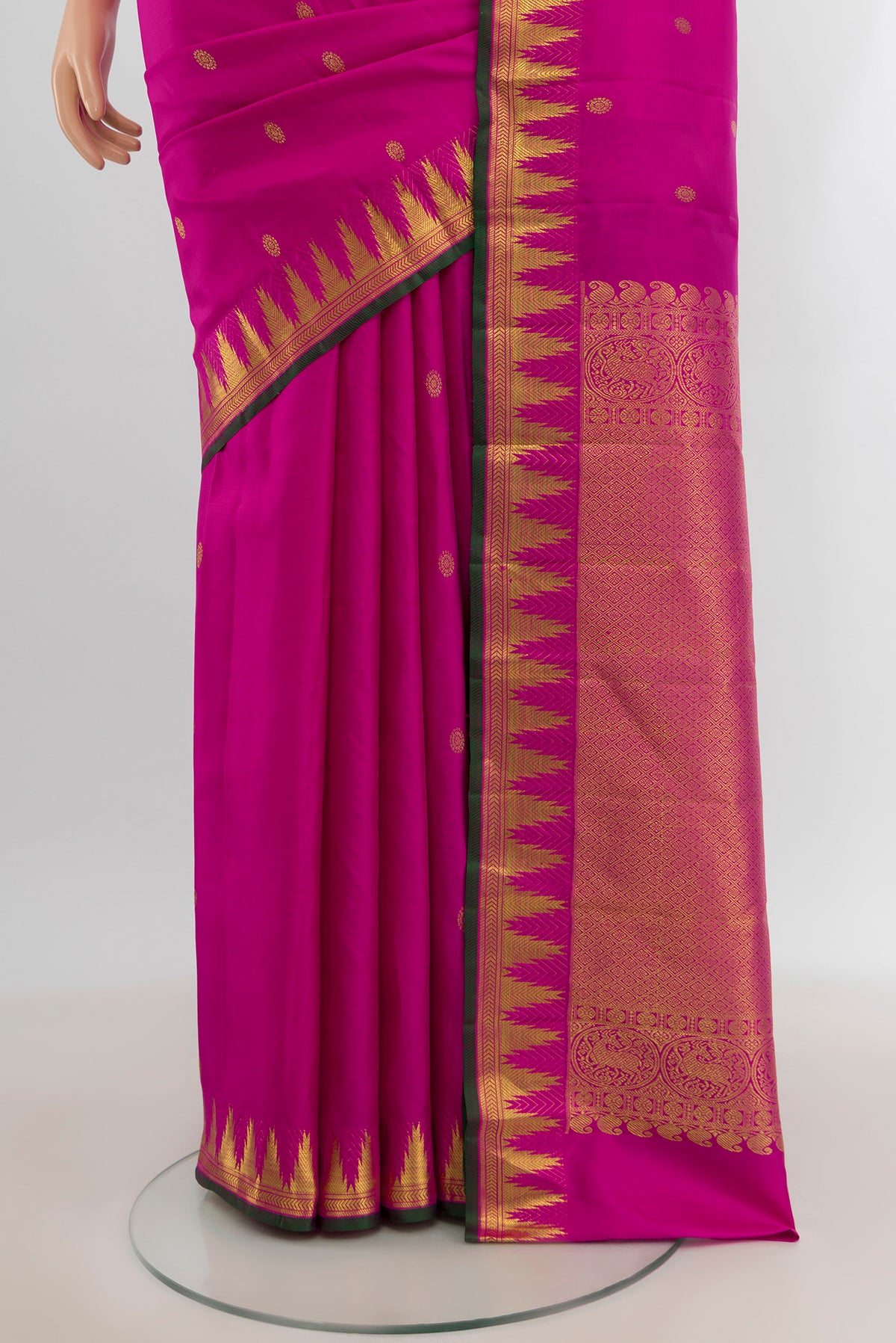 Pleats and pallu of Rani Pink Kanjivaram Silk Saree with Zari Butta on the body and Zari Border. 