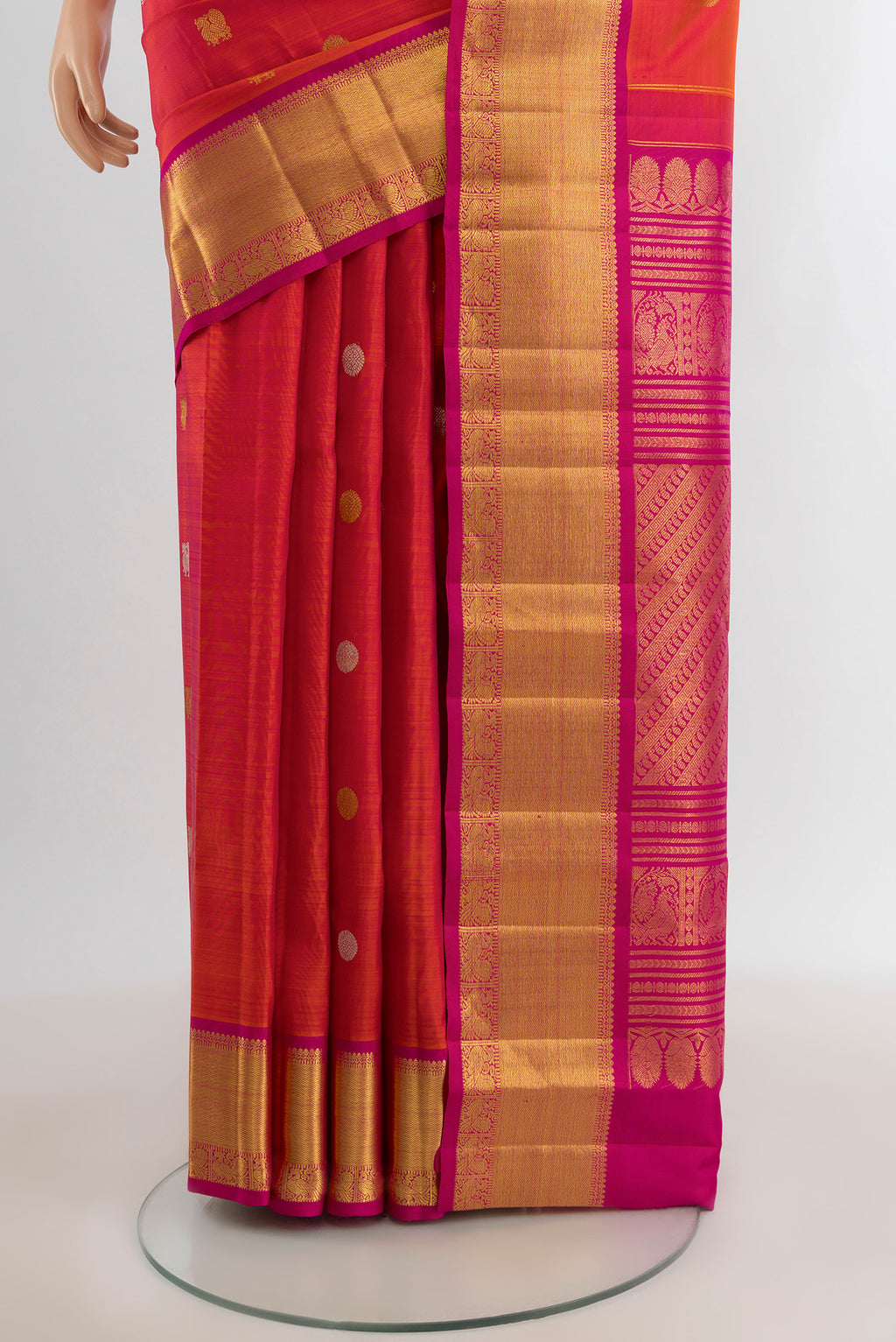 Pleats and pallu of Coral Kanjivaram Silk Saree with Zari Butta on the body and Zari Border. 