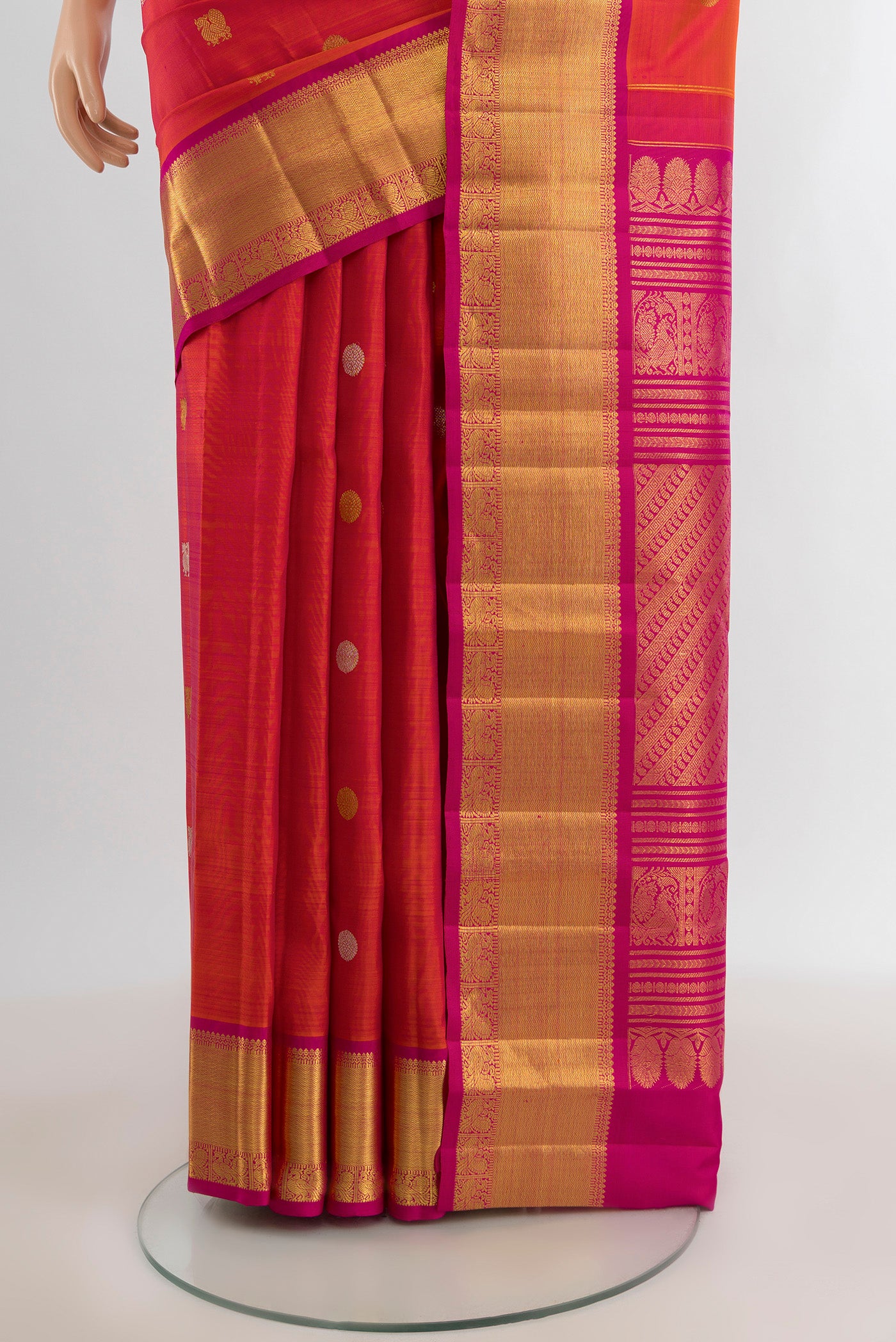 Pleats and pallu of Coral Kanjivaram Silk Saree with Zari Butta on the body and Zari Border. 