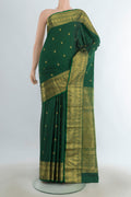 Pure Silk Pure Zari Mint Green Kanjivaram Saree with Zari Butta on the body and Silk Border.  displayed on a mannequin