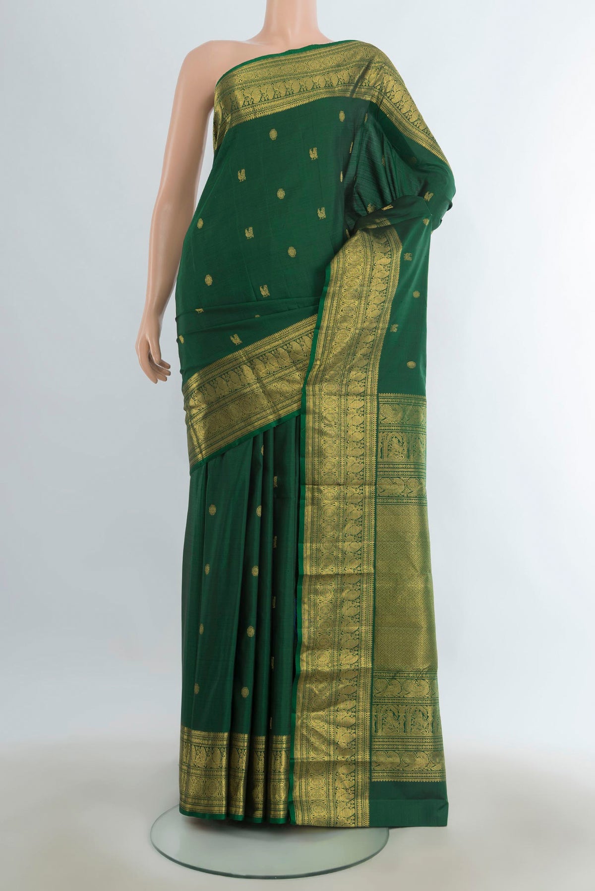 Pure Silk Pure Zari Mint Green Kanjivaram Saree with Zari Butta on the body and Silk Border.  displayed on a mannequin