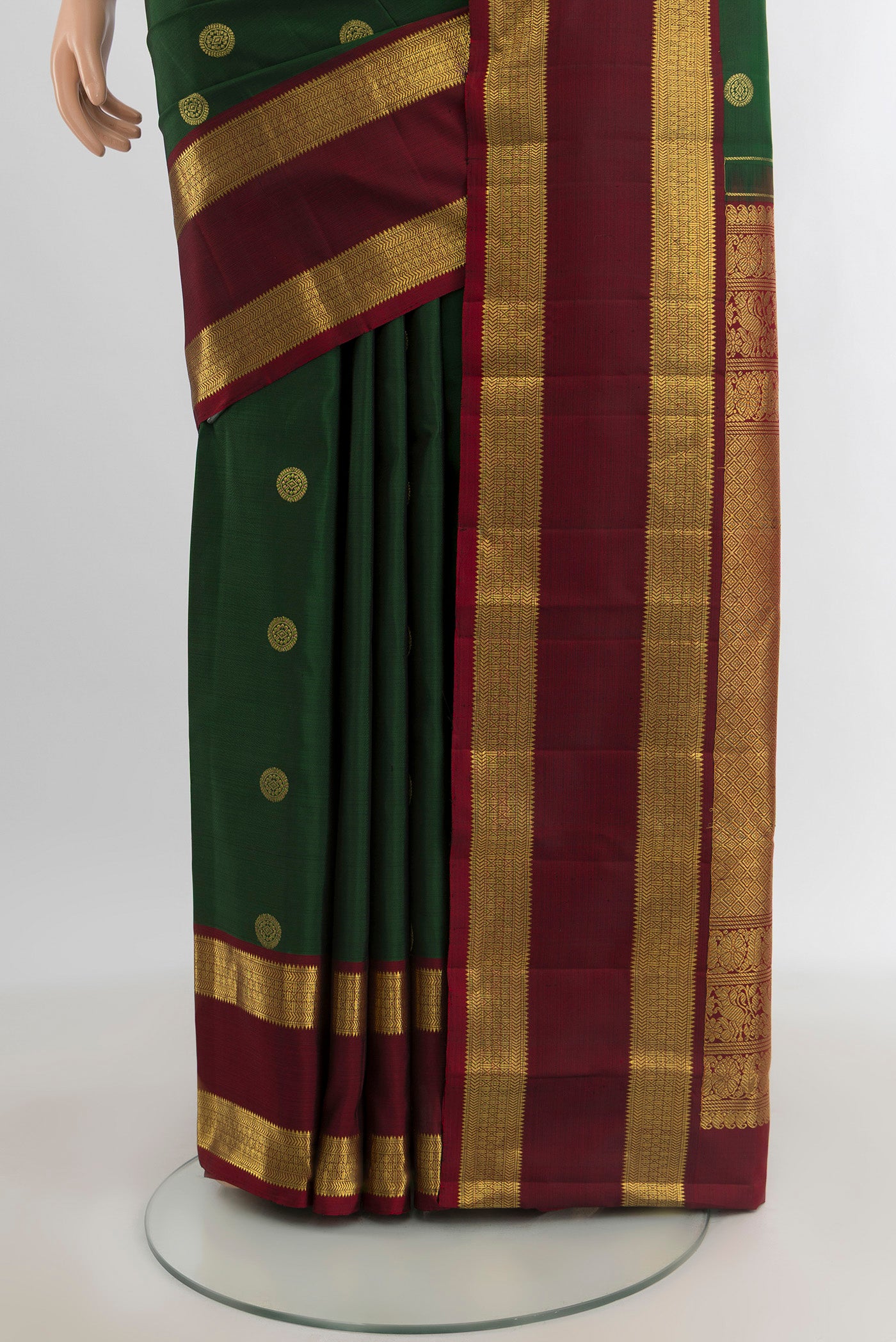 Pleats and pallu of Bottle Green Kanjivaram Silk Saree with Zari Butta on the body and Zari Border. 