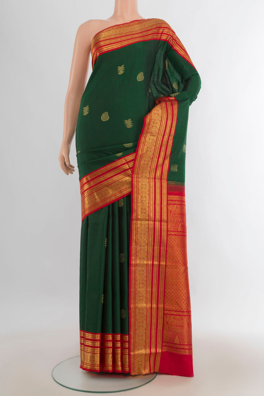 Pure Silk Bottle Green Kanchipuram Saree with Zari Butta on the body and Silk Border.  displayed on a mannequin
