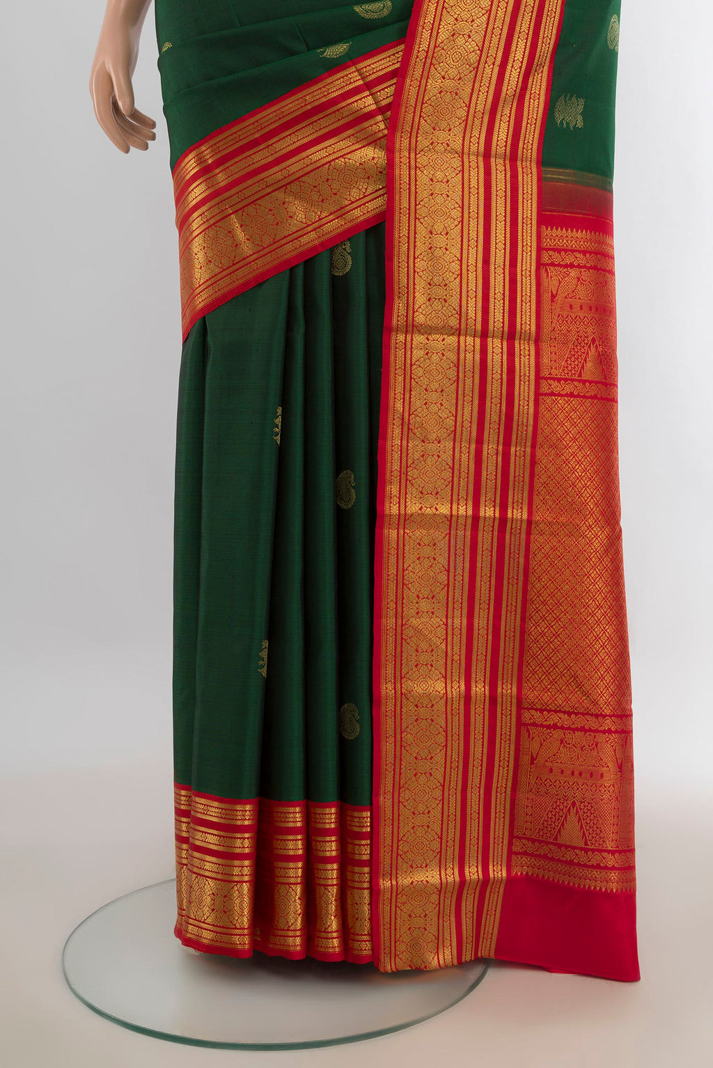 Pleats and pallu of Pure Silk Bottle Green Kanchipuram Saree with Zari Butta on the body and Silk Border. 