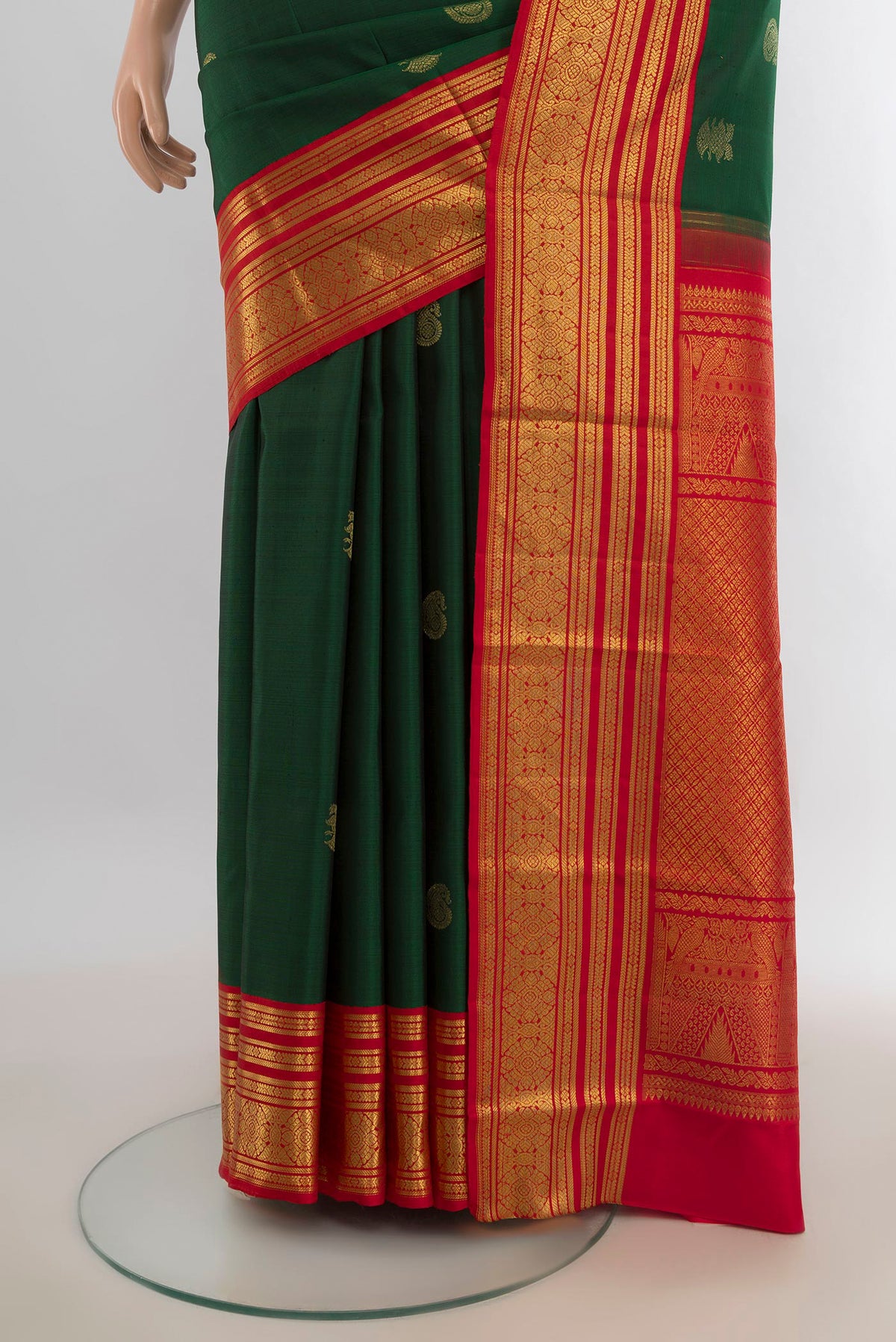 Pleats and pallu of Pure Silk Bottle Green Kanchipuram Saree with Zari Butta on the body and Silk Border. 