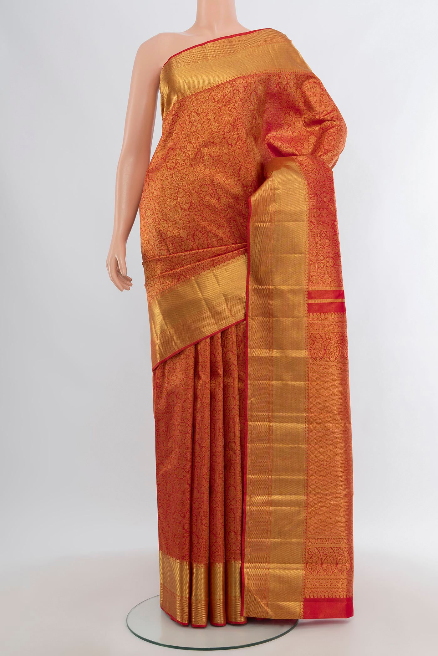 Pure Silk Pure Zari Brick Orange Kanjivaram Tissue Saree with Zari Brocade on the body and Zari Border.  displayed on a mannequin