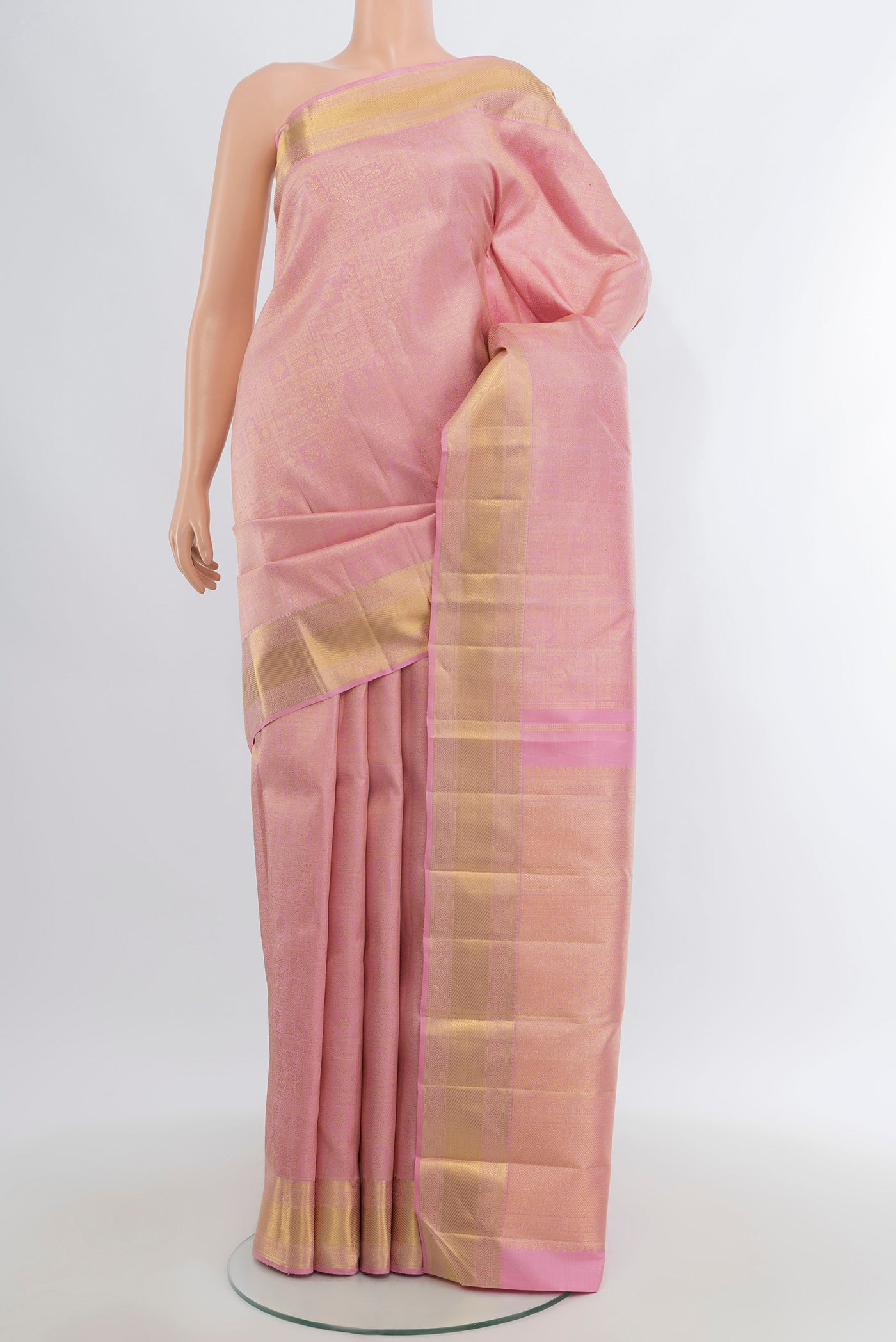 Pure Silk Pure Zari Rose Gold Kanjivaram Saree with Zari Brocade on the body and Zari Border.  displayed on a mannequin