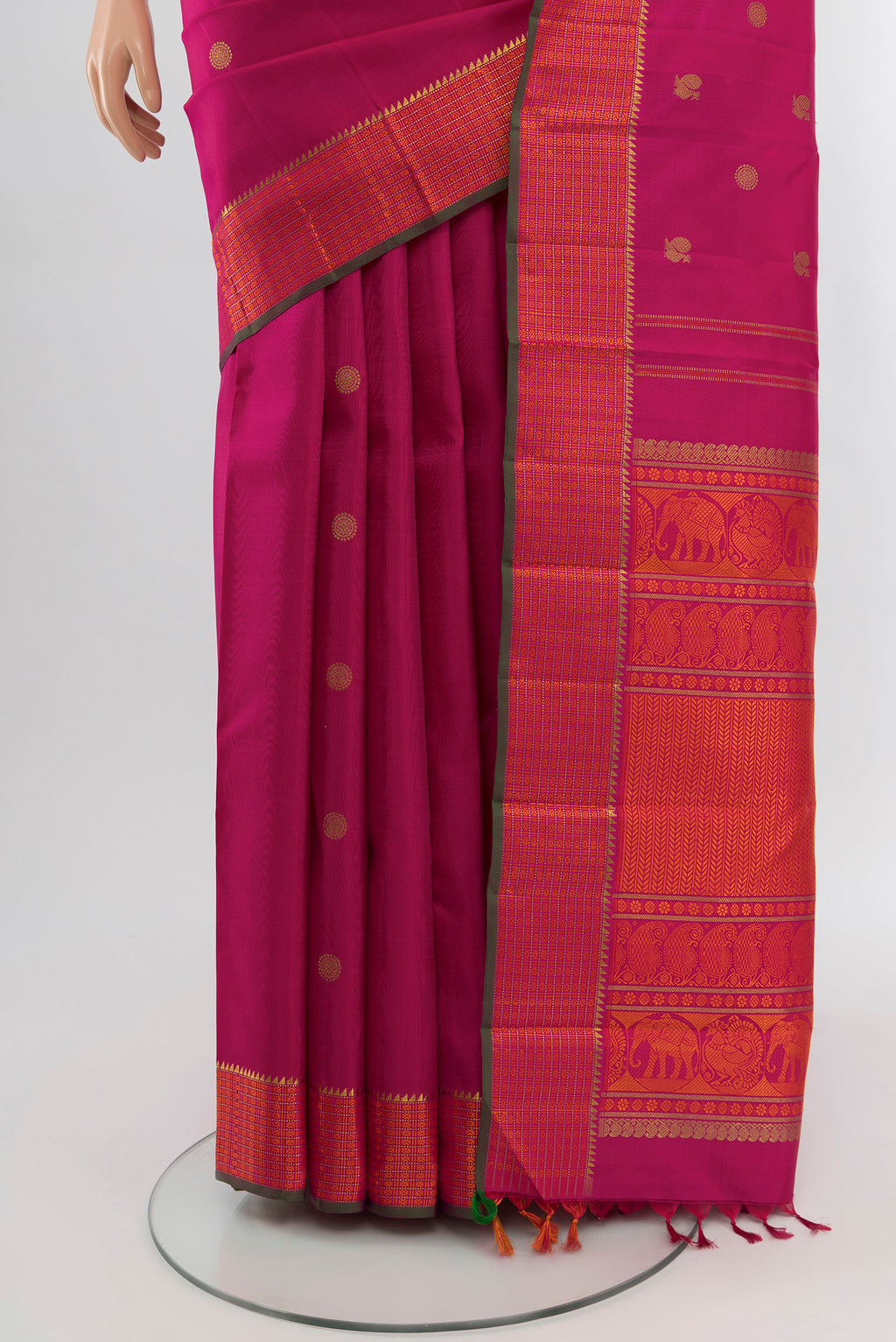 Pleats and pallu of Pure Silk Pure Zari Rani Pink Kanchipuram Saree with Zari Butta on the body and Zari And Thread Border. 