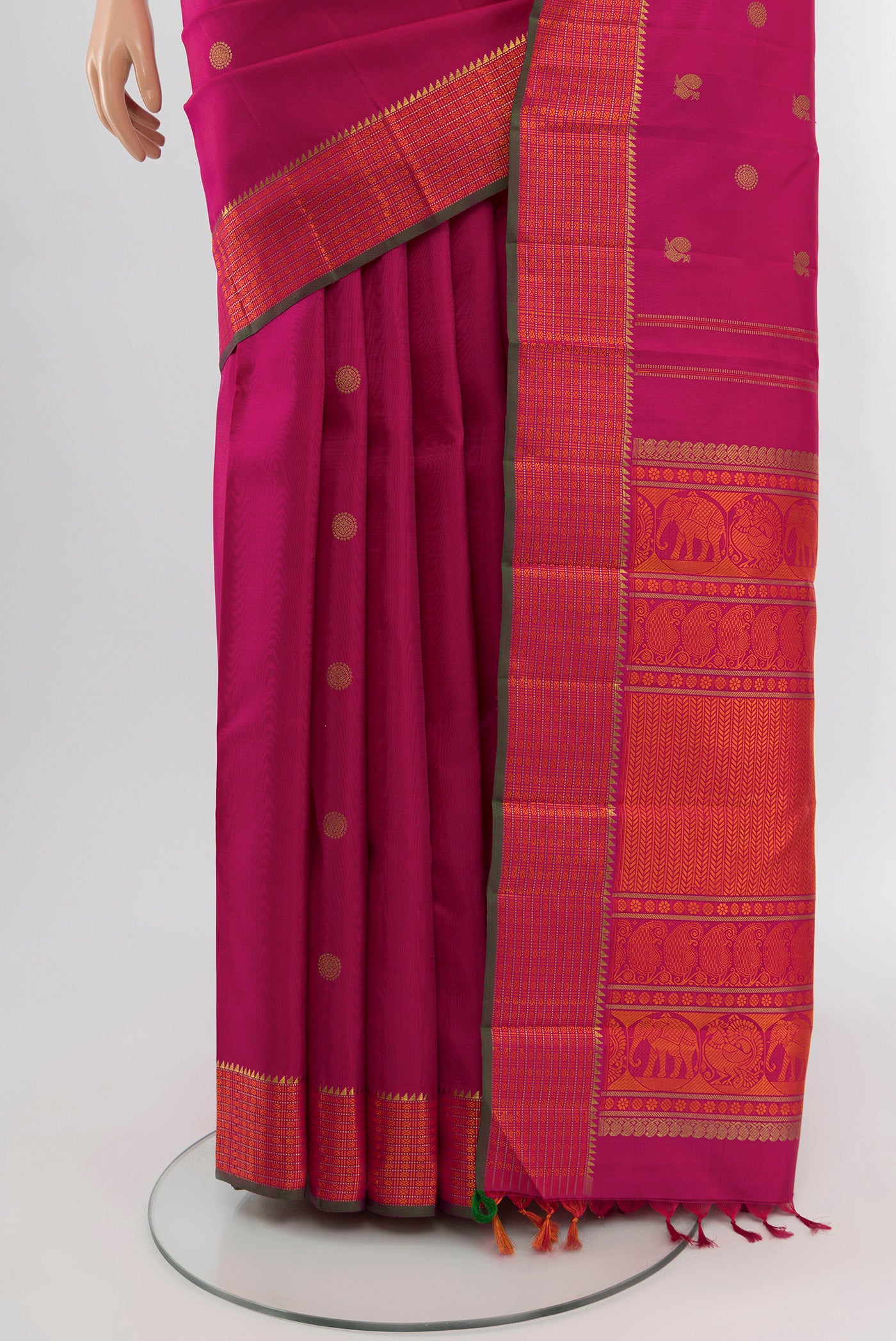 Pleats and pallu of Pure Silk Pure Zari Rani Pink Kanchipuram Saree with Zari Butta on the body and Zari And Thread Border. 