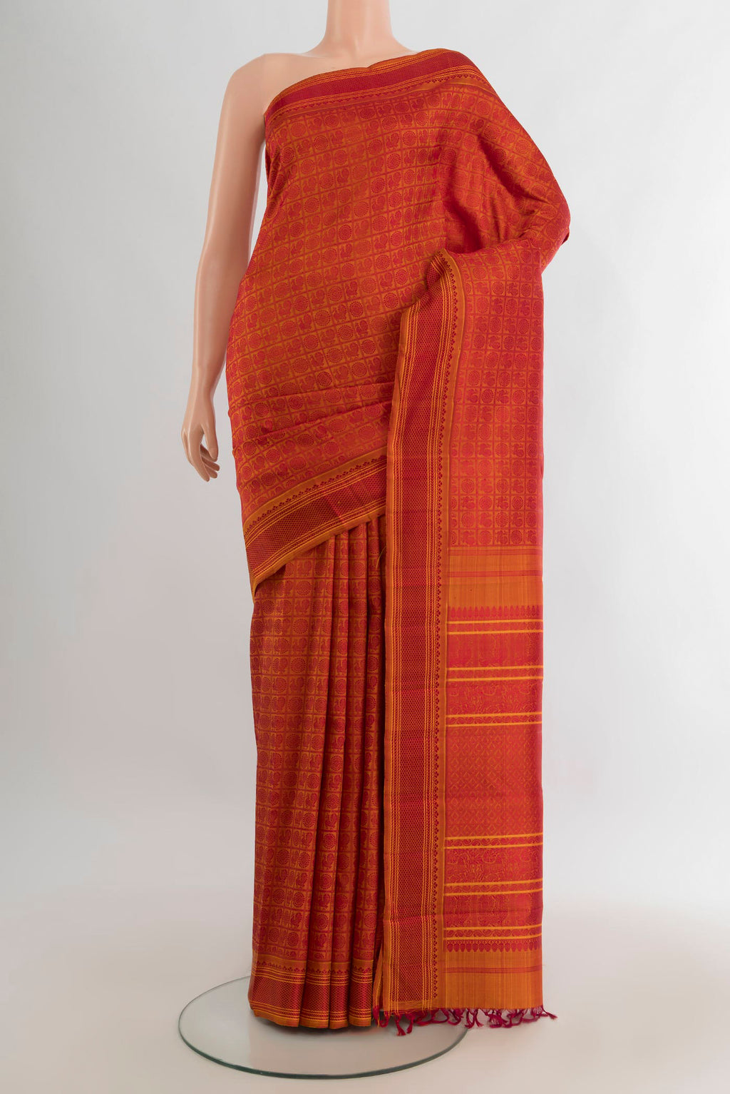 Pure Silk Orange Kanchipuram Saree with Jacquard design on the body and Thread Border.  displayed on a mannequin