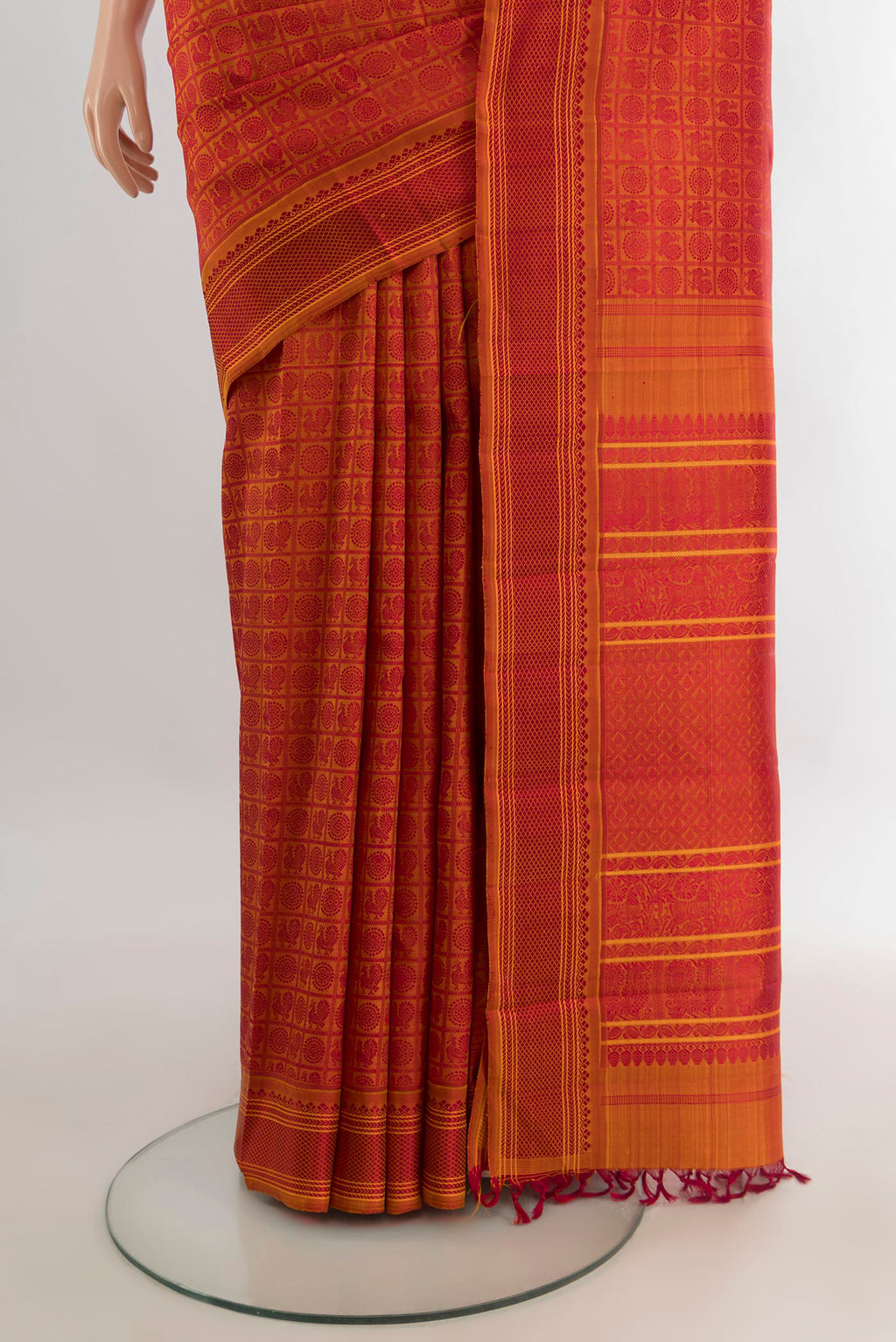Pleats and pallu of Pure Silk Orange Kanchipuram Saree with Jacquard design on the body and Thread Border. 