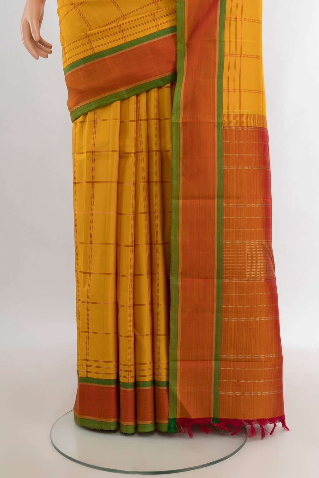 Pleats and pallu of Mustard Kanjivaram Silk Saree with Checked design on the body and Plain Border. 