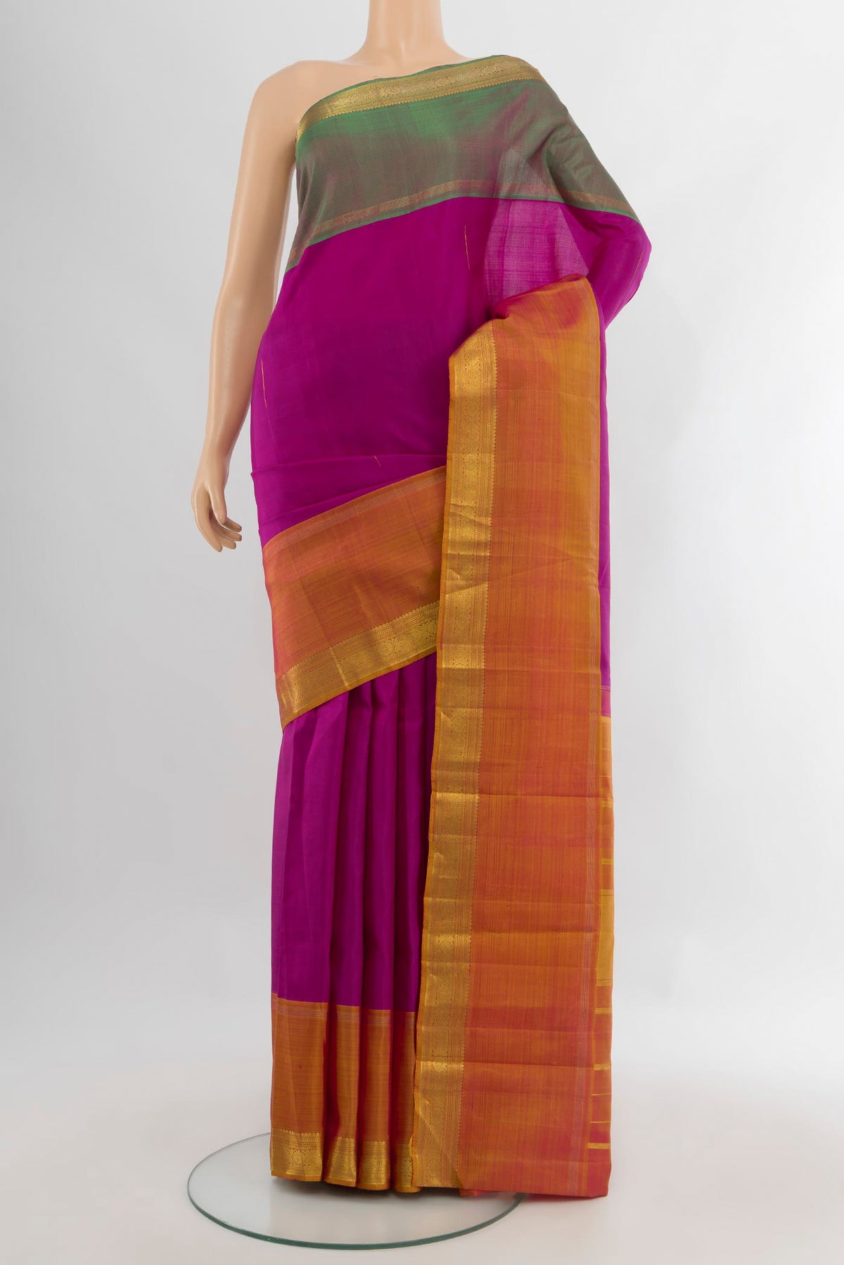 Magenta Kanjivaram Silk Saree with Zari Butta on the body and Ganga Jamuna Border.  displayed on a mannequin
