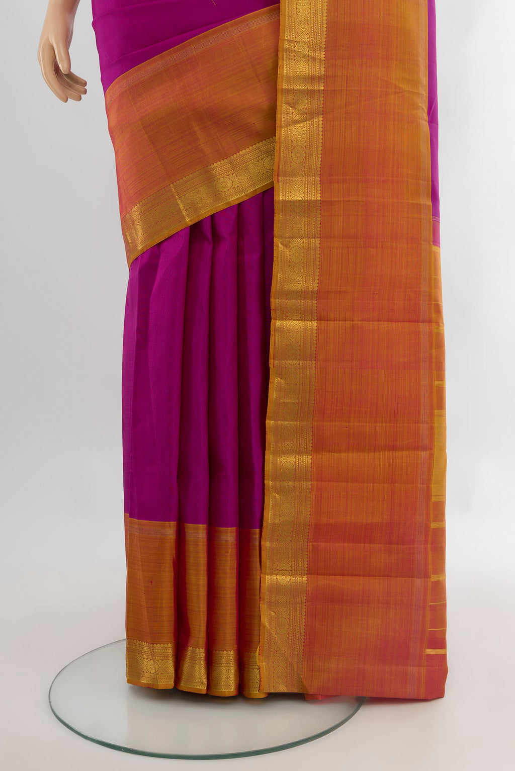 Pleats and pallu of Magenta Kanjivaram Silk Saree with Zari Butta on the body and Ganga Jamuna Border. 