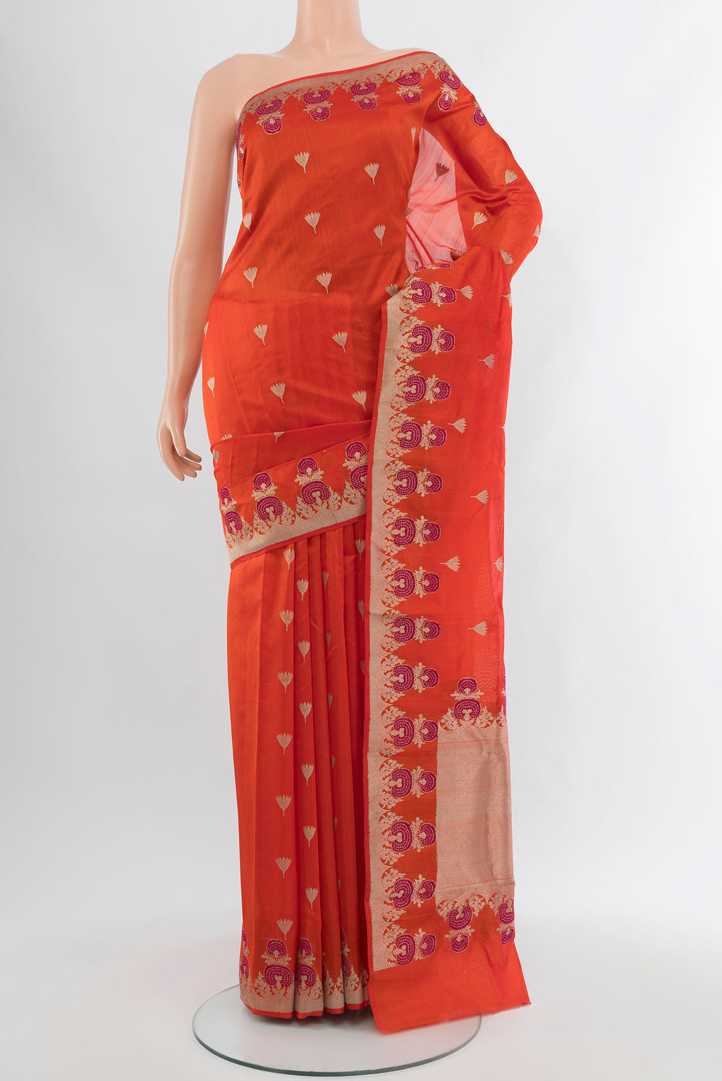 Orange Chanderi Silk Cotton Saree with Zari Butta on the body and Zari Border.  displayed on a mannequin