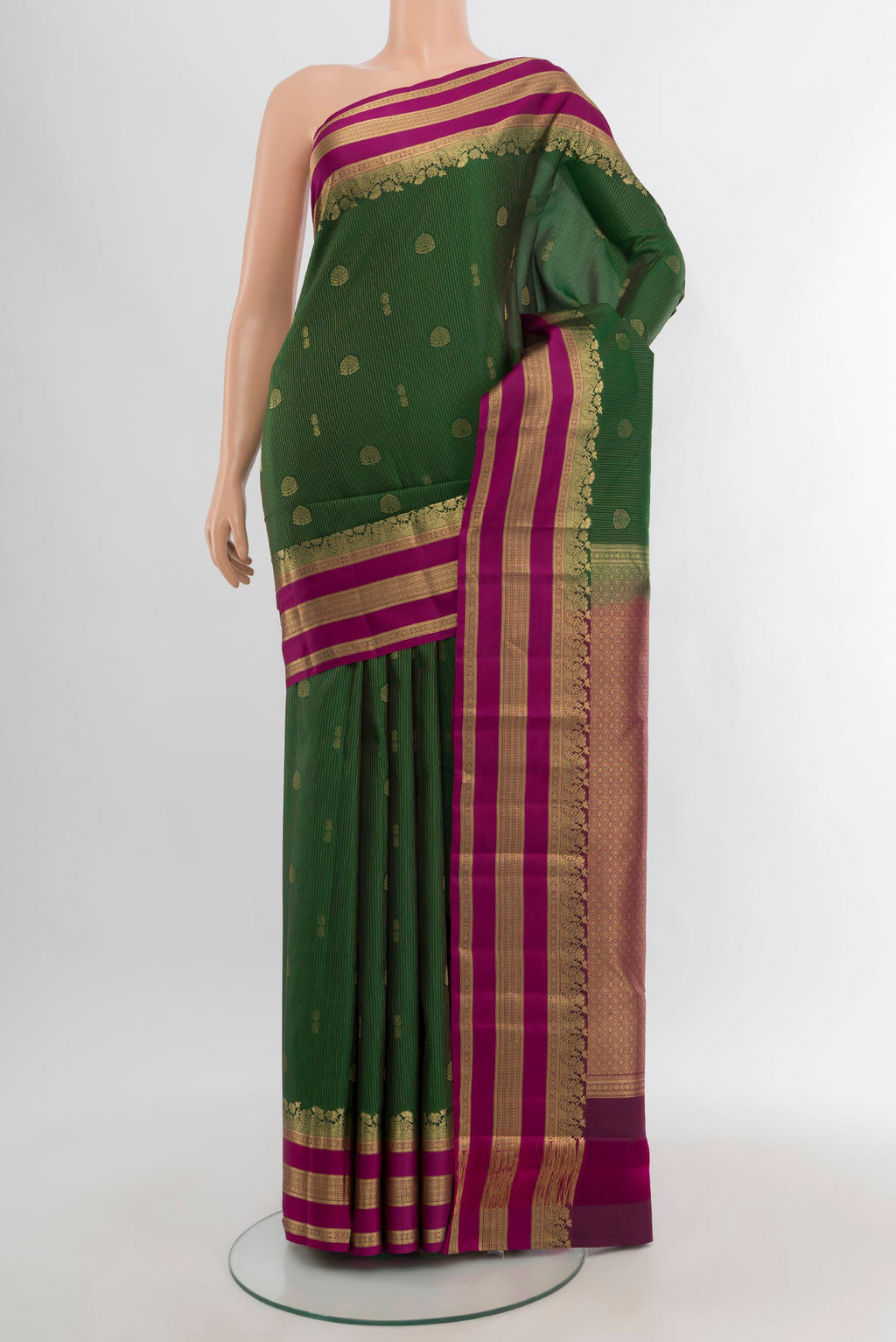 Bottle Green Kanjivaram Silk Saree with Zari Butta on the body and Zari Border.  displayed on a mannequin