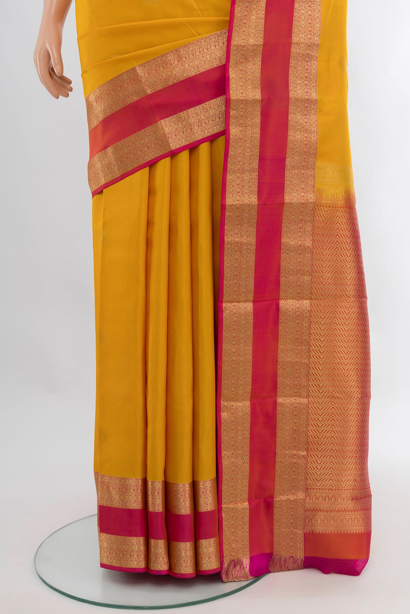 Pleats and pallu of Mustard Kanchipuram Silk Saree with Zari Butta on the body and Zari Border. 