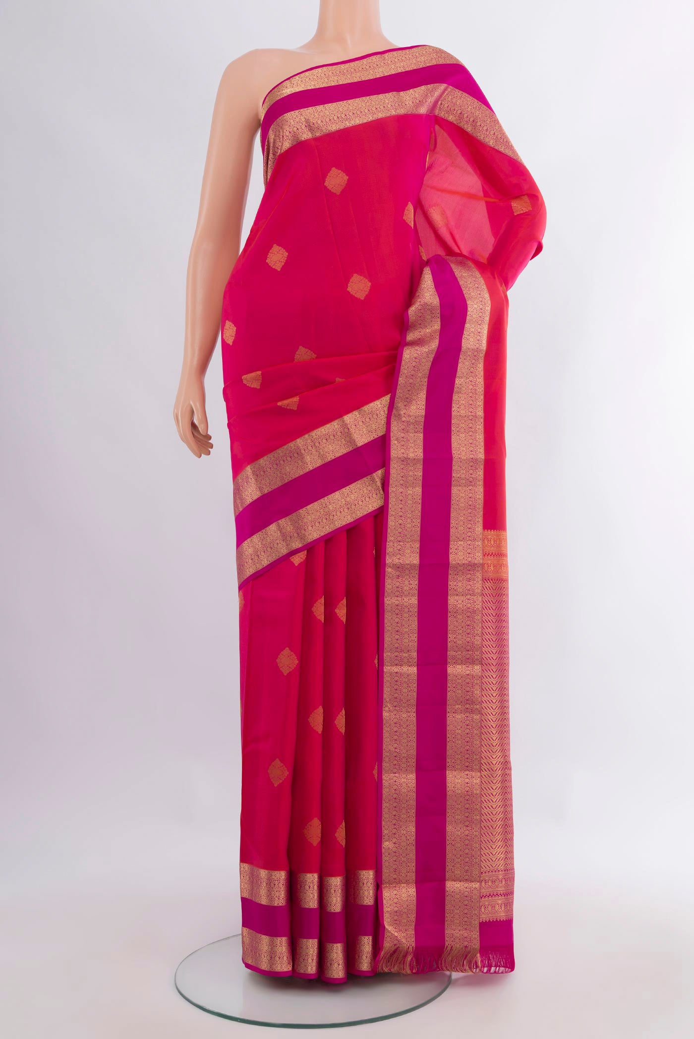 Pure Silk Pink Kanchipuram Saree with Zari Butta on the body and Zari Border.  displayed on a mannequin