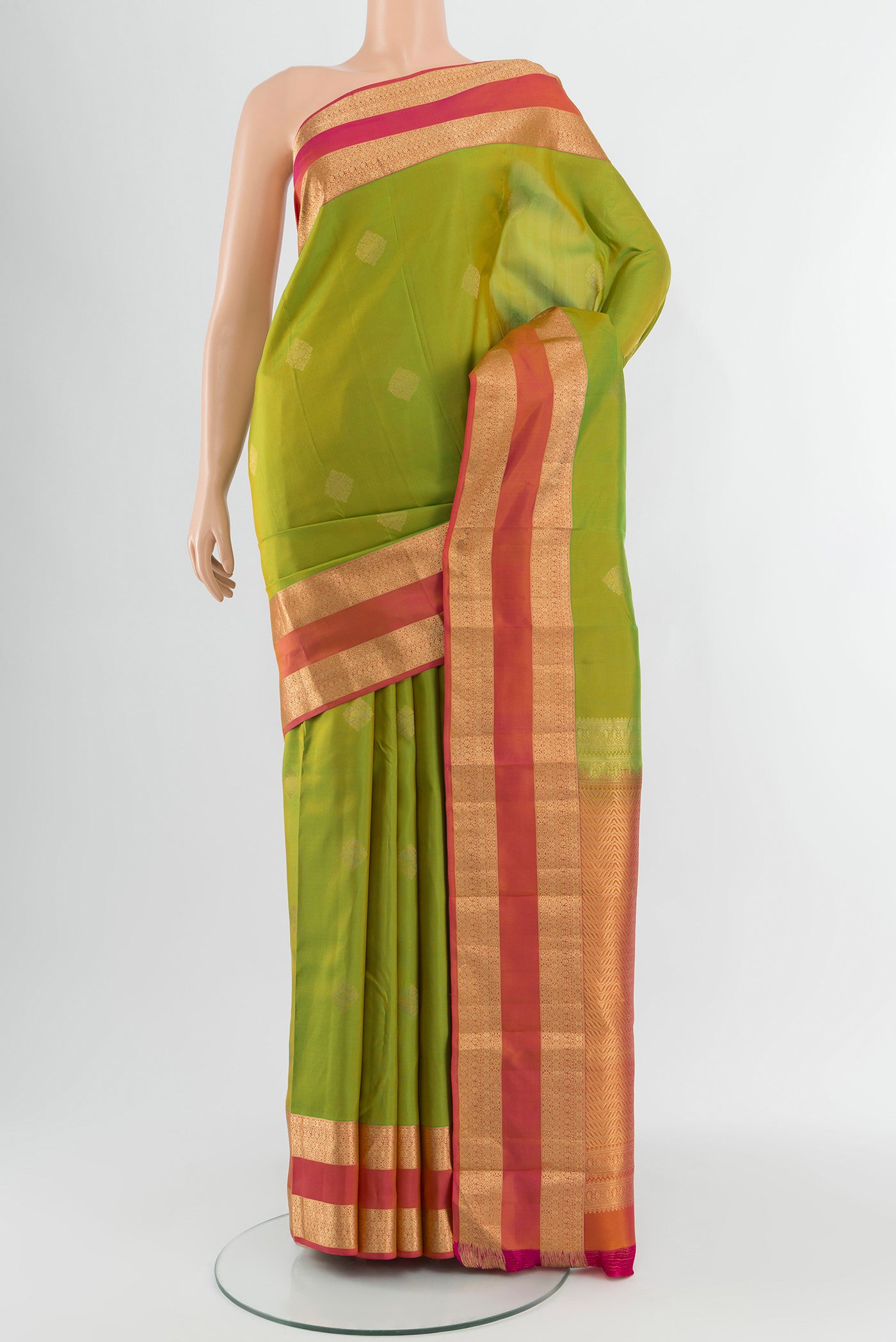 Green Kanchipuram Silk Saree with Zari Butta on the body and Zari Border.  displayed on a mannequin