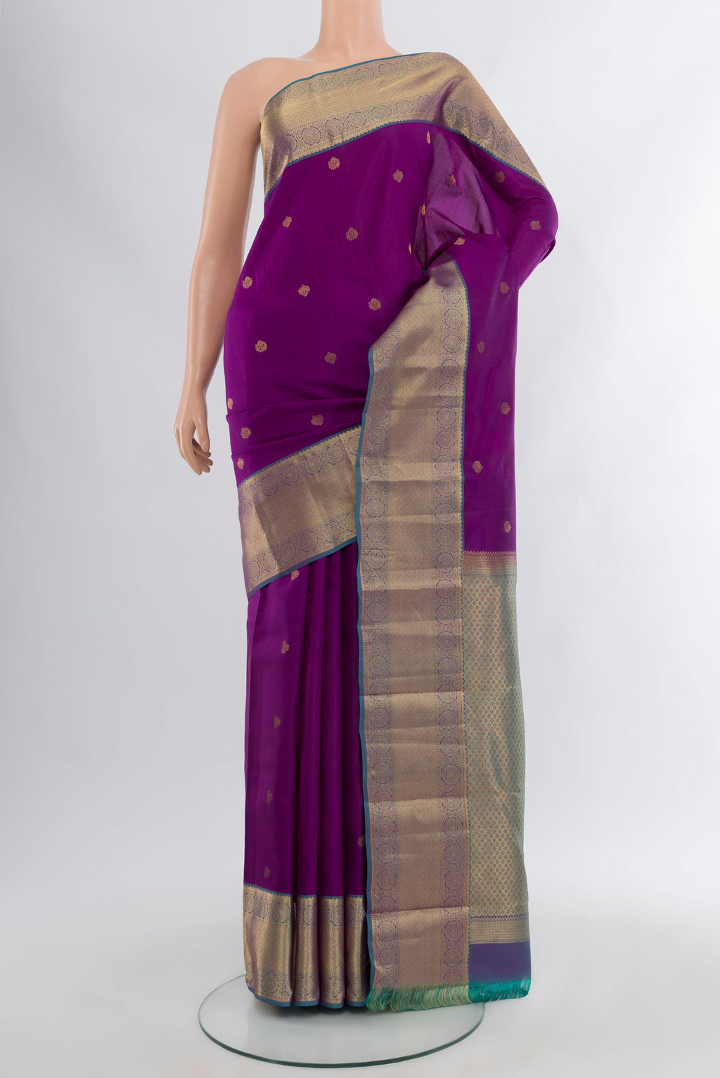 Purple Kanchipuram Silk Saree with Zari Butta on the body and Zari Border.  displayed on a mannequin