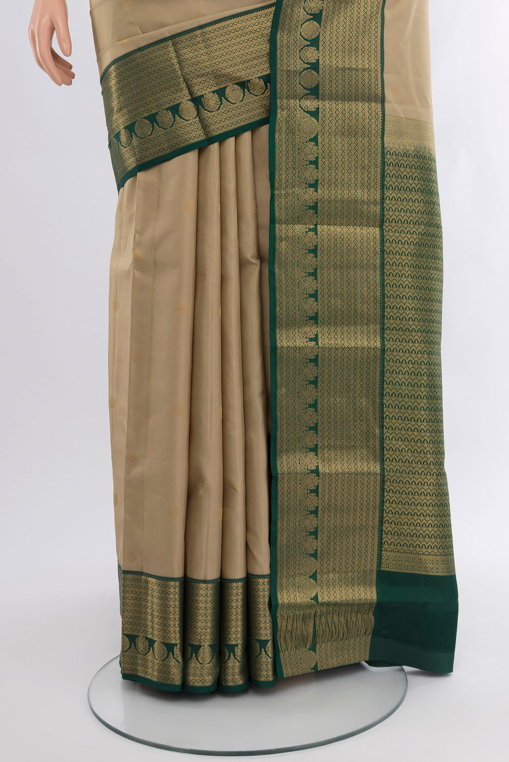 Pleats and pallu of Beige Kanchipuram Silk Saree with Zari Butta on the body and Zari Border. 