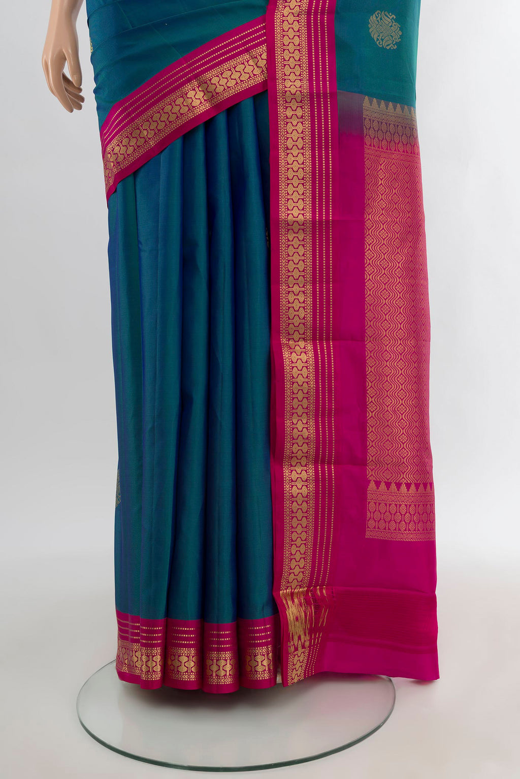 Pleats and pallu of Peacock Blue Kanchipuram Silk Saree with Zari Butta on the body and Zari Border. 