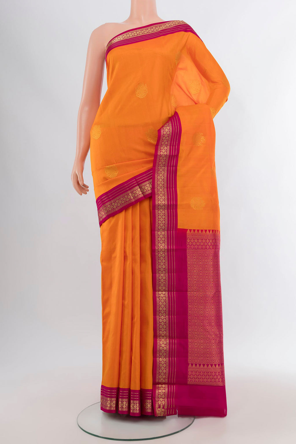 Orange Kanchipuram Silk Saree with Zari Butta on the body and Zari Border.  displayed on a mannequin