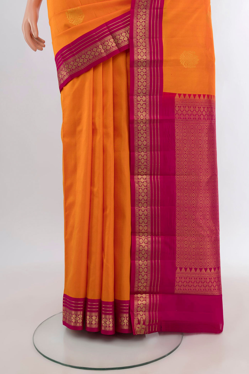 Pleats and pallu of Orange Kanchipuram Silk Saree with Zari Butta on the body and Zari Border. 