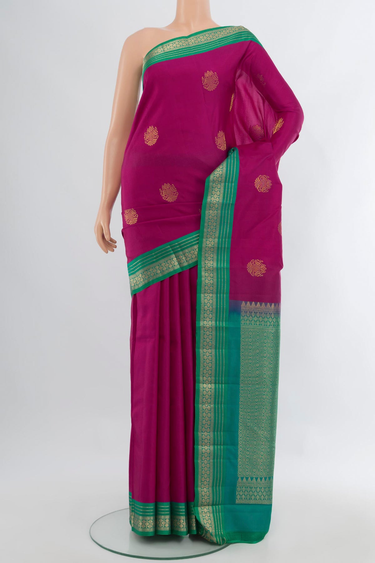 Magenta Kanchipuram Silk Saree with Zari Butta on the body and Zari Border.  displayed on a mannequin