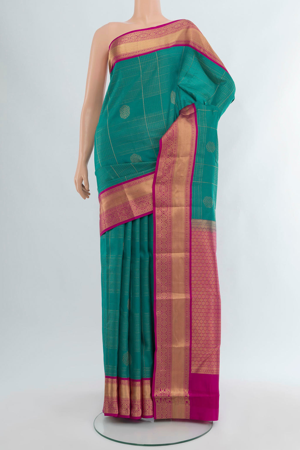 Peacock Blue Kanjivaram Silk Saree with Checked design on the body and Zari Border.  displayed on a mannequin