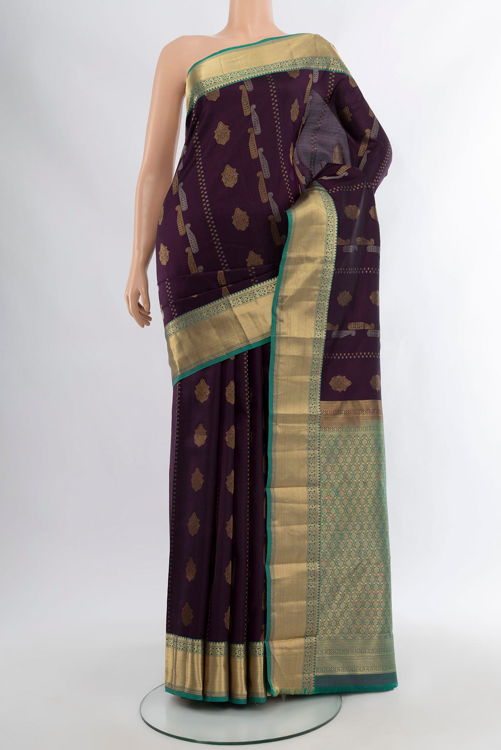 Purple Kanjivaram Silk Saree with Zari Butta on the body and Zari Border.  displayed on a mannequin