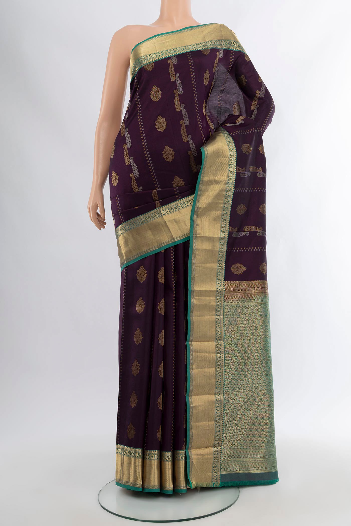 Purple Kanjivaram Silk Saree with Zari Butta on the body and Zari Border.  displayed on a mannequin