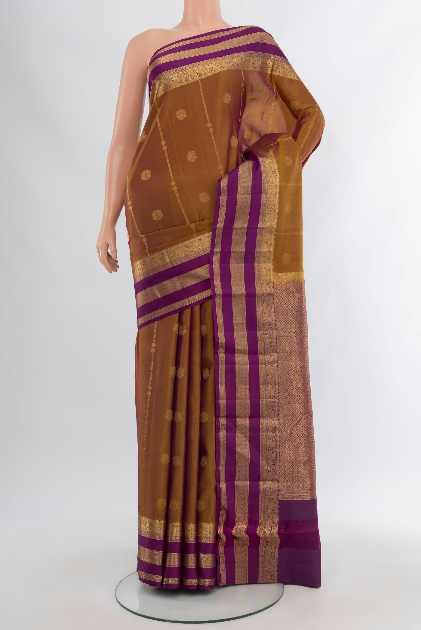 Brown Kanchipuram Silk Saree with Zari Butta on the body and Zari Border.  displayed on a mannequin