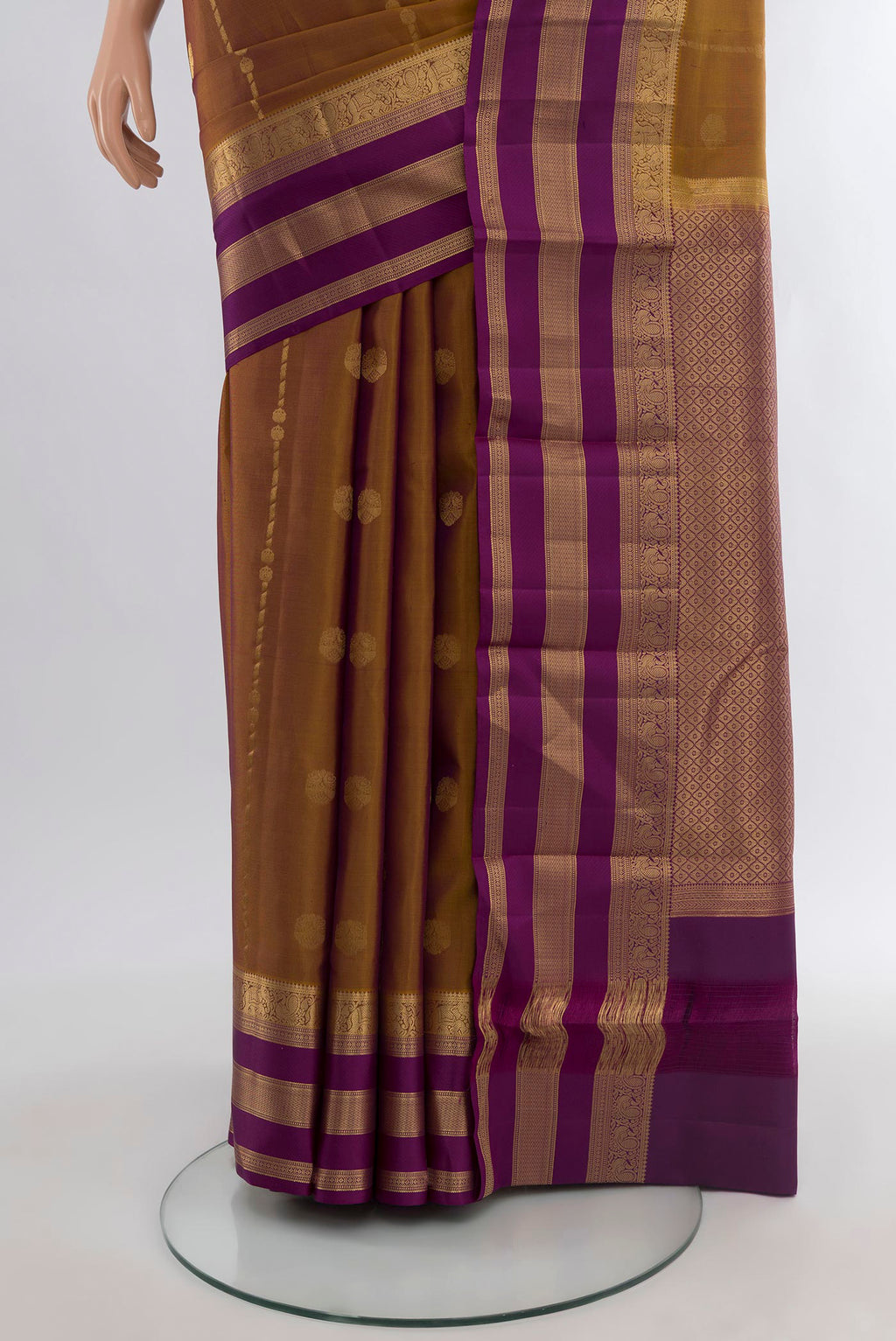 Pleats and pallu of Brown Kanchipuram Silk Saree with Zari Butta on the body and Zari Border. 