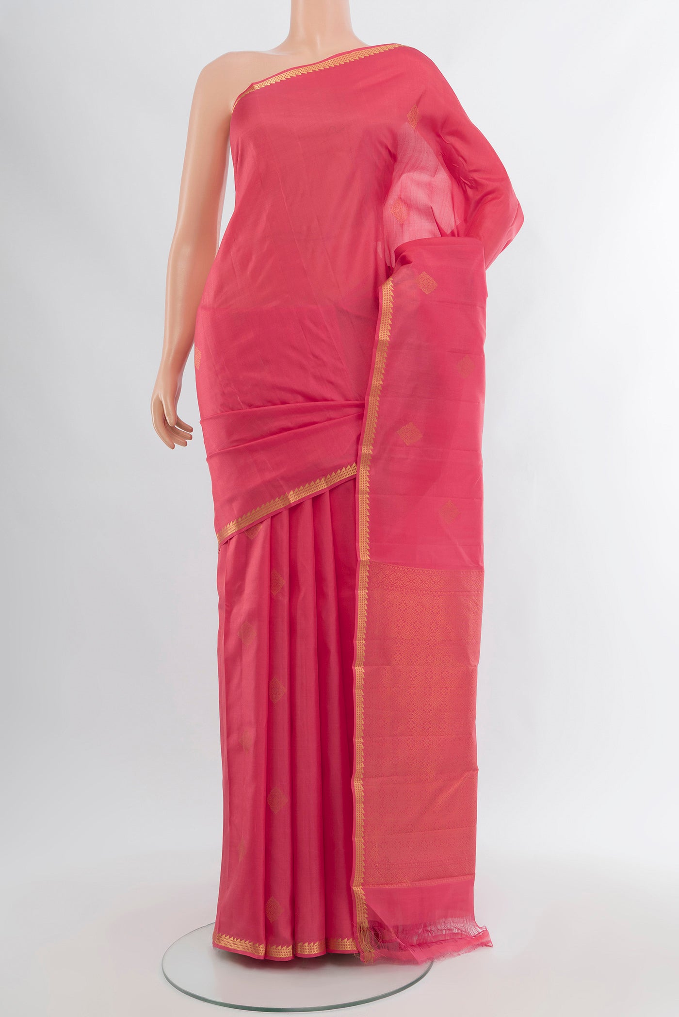 Pink Kanjivaram Silk Saree with Zari Butta on the body and Zari Border.  displayed on a mannequin