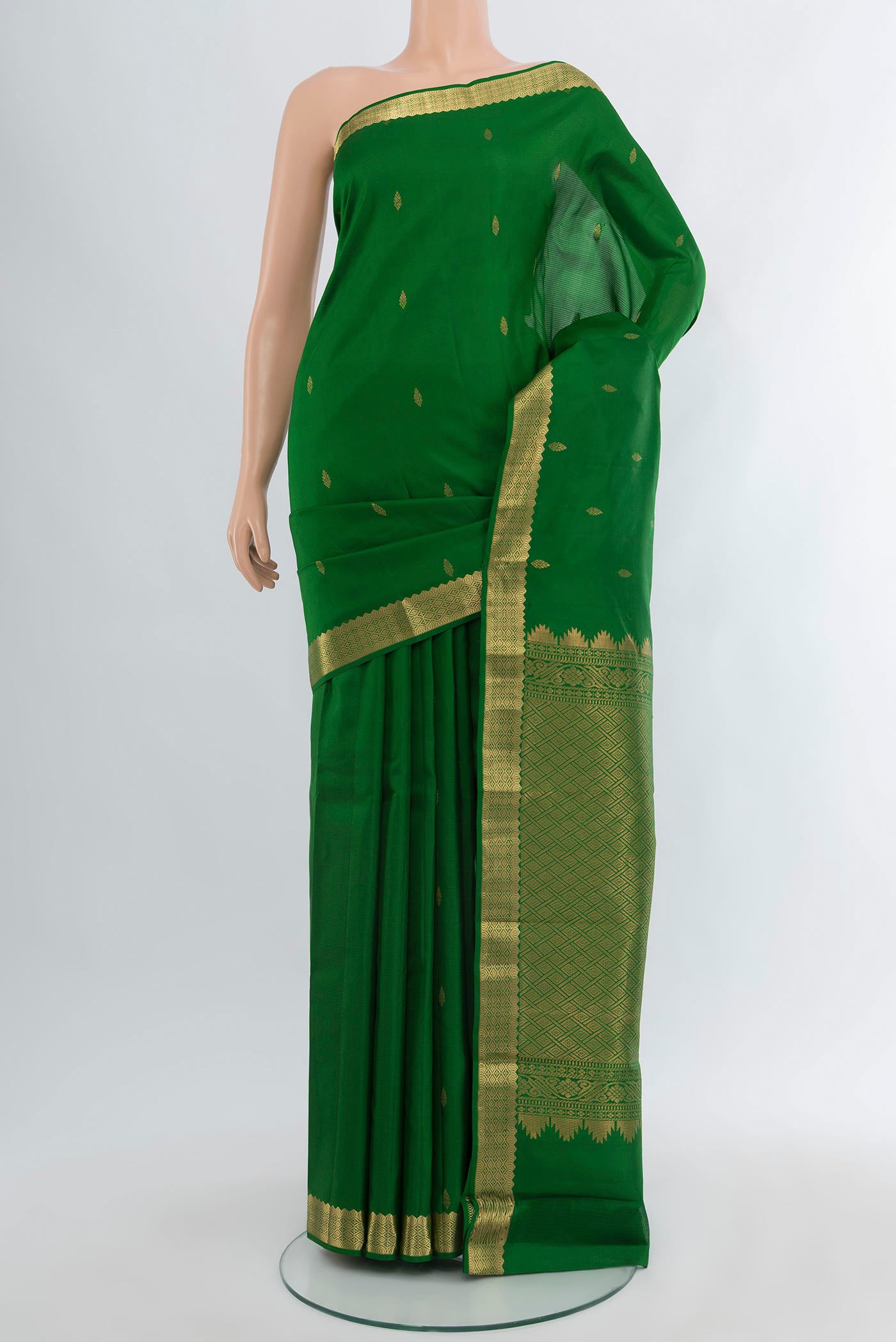 Green Kanjivaram Silk Saree with Zari Butta on the body and Zari Border.  displayed on a mannequin