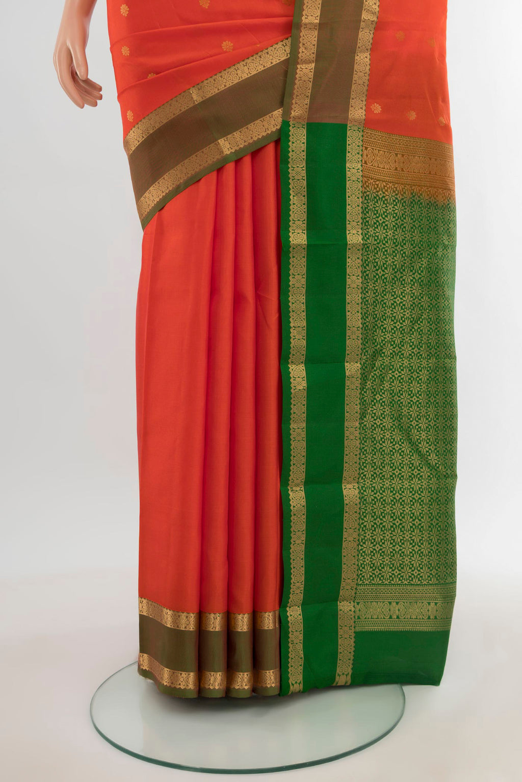 Pleats and pallu of Orange Kanjivaram Silk Saree with Zari Butta on the body and Zari Border. 