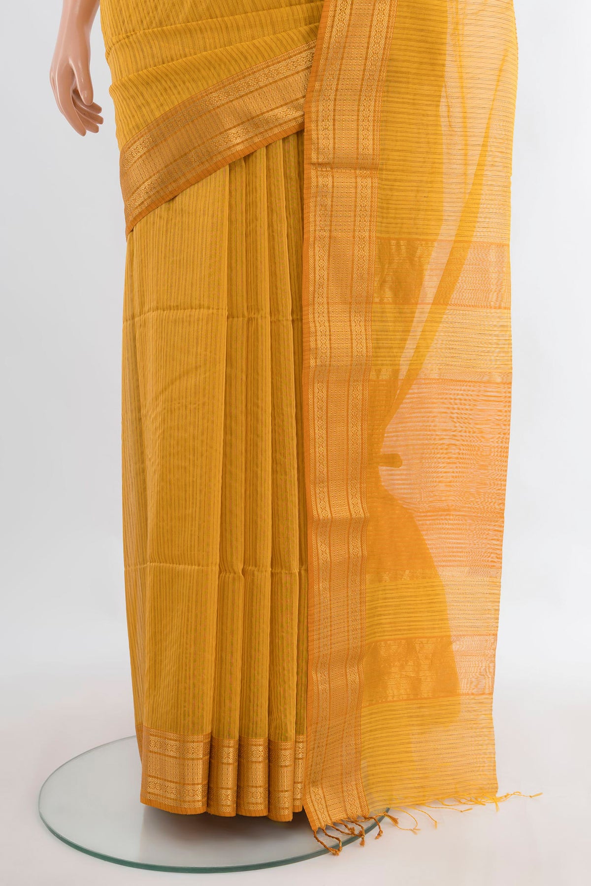 Pleats and pallu of Mustard Maheshwari Cotton Saree with Stripes on the body and Zari Border. 