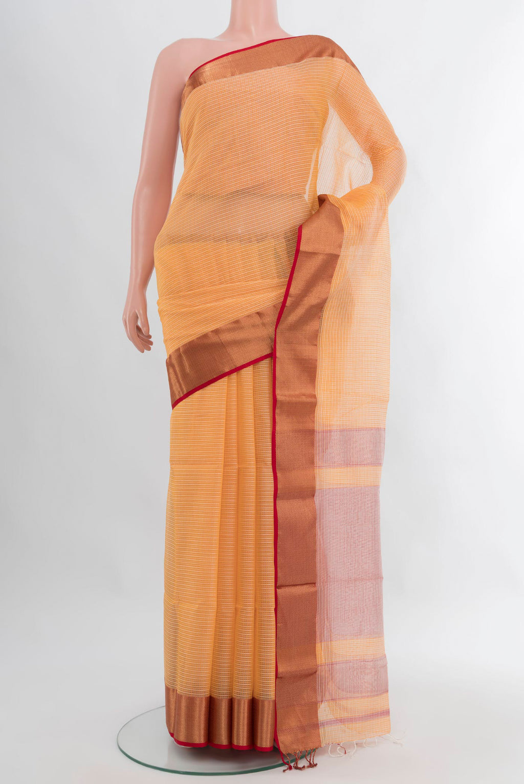 Peach Maheshwari Silk Cotton Saree with Stripes on the body and Zari Border.  displayed on a mannequin