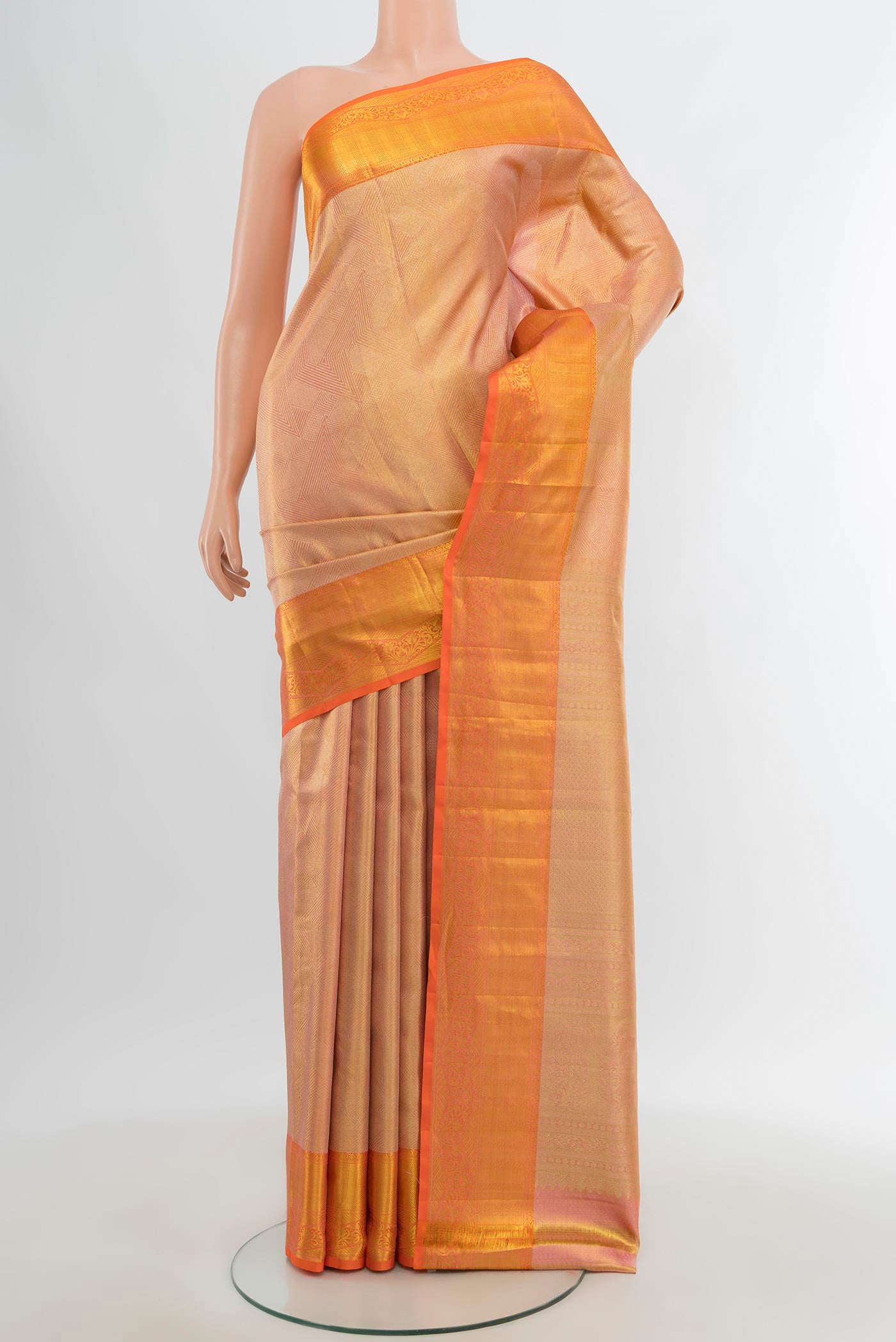 Golden Peach Kanchipuram Tissue Silk Saree with Zari Brocade on the body and Zari Border.  displayed on a mannequin
