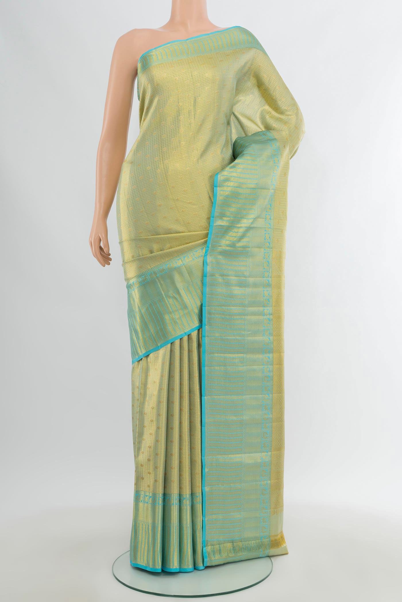Golden Kanchipuram Tissue Silk Saree with Zari Brocade on the body and Zari Border.  displayed on a mannequin