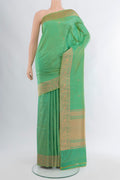Light Green Banarasi Katan Silk Saree with Zari Butta on the body and Zari Border.  displayed on a mannequin
