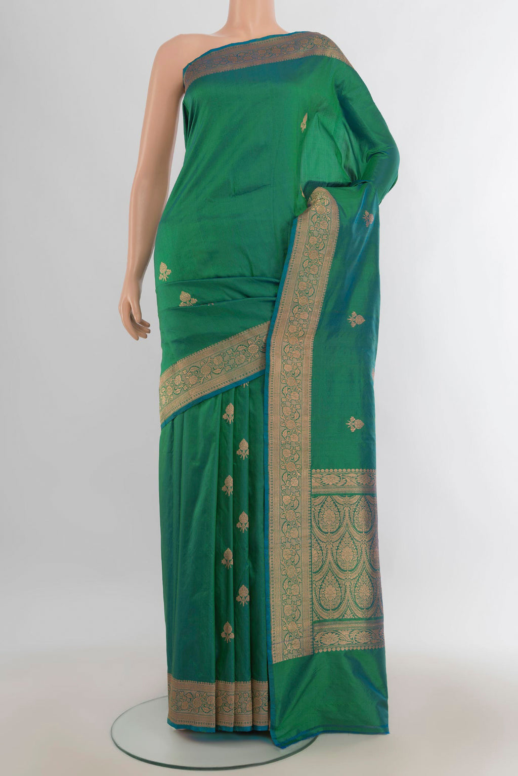 Pure Silk Light Green Banarasi Katan Saree with Zari Butta on the body and Silk Border.  displayed on a mannequin