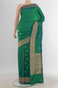 Pure Silk Light Green Banarasi Katan Saree with Zari Butta on the body and Silk Border.  displayed on a mannequin