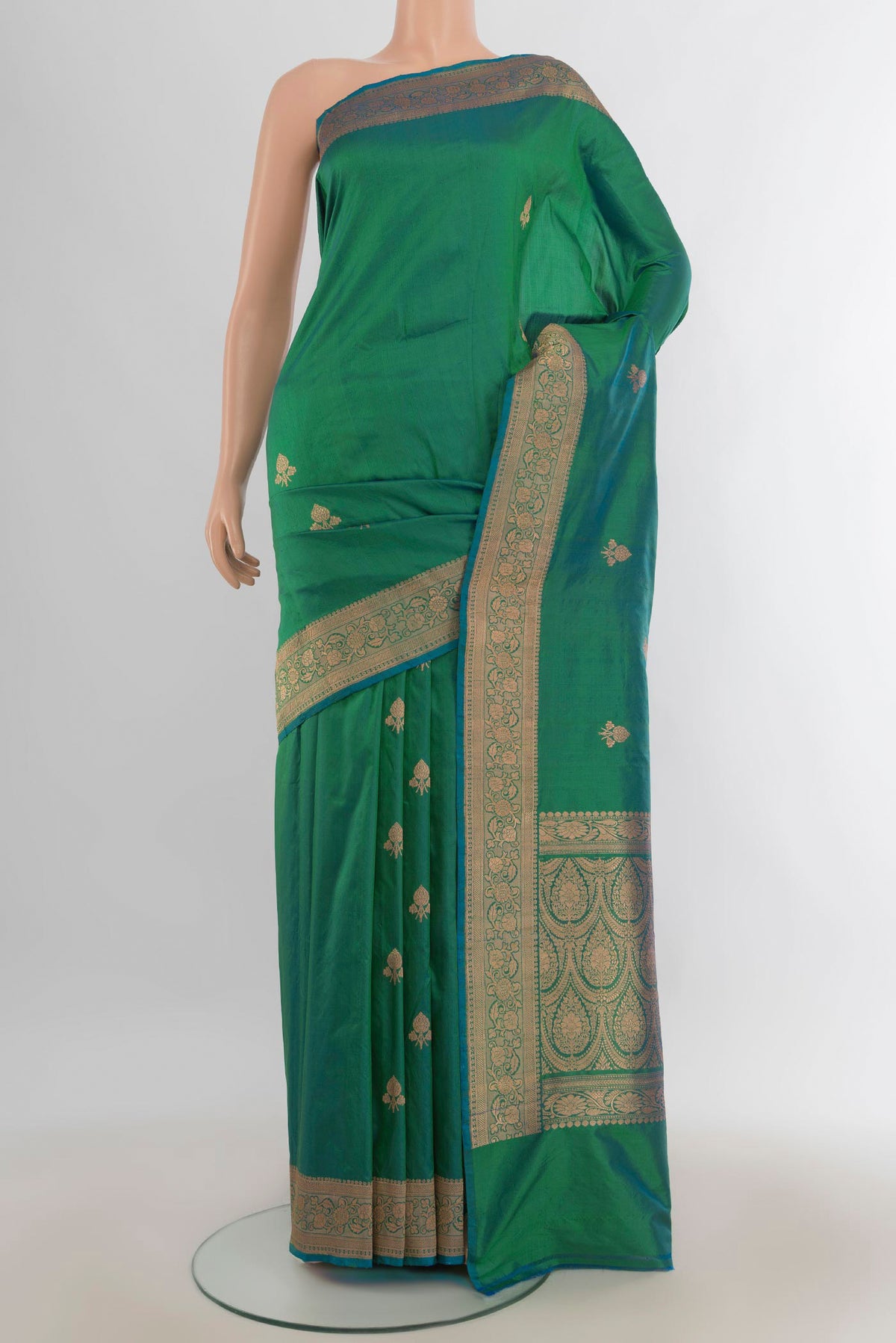 Pure Silk Light Green Banarasi Katan Saree with Zari Butta on the body and Silk Border.  displayed on a mannequin
