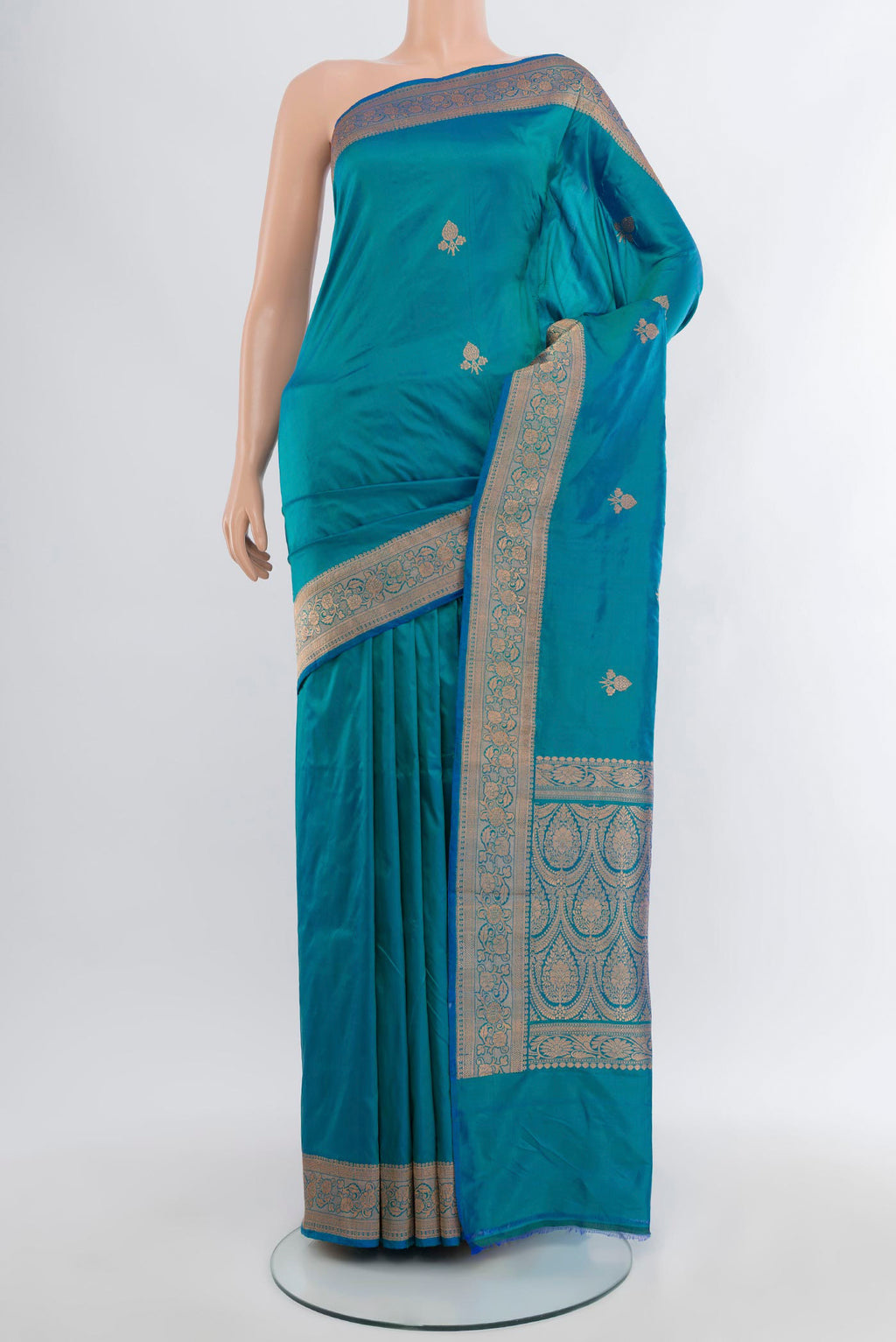 Peacock Blue Banarasi Katan Silk Saree with Zari Butta on the body and Zari Border.  displayed on a mannequin