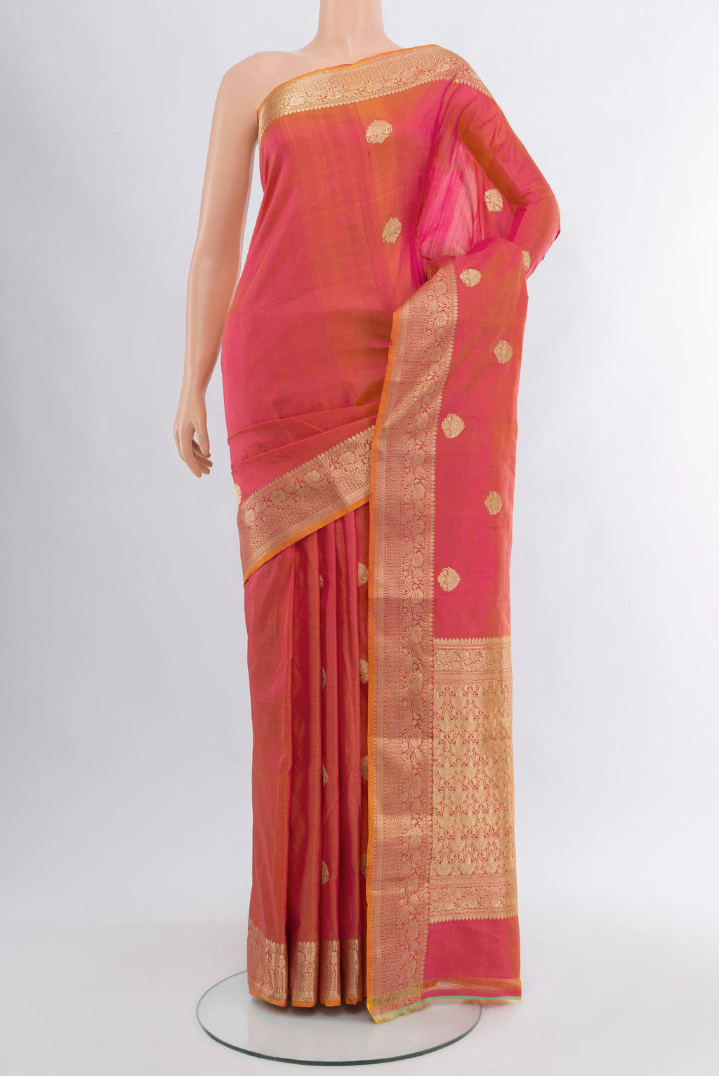 Pinkish Yellow Banarasi Katan Silk Saree with Zari Butta on the body and Zari Border.  displayed on a mannequin