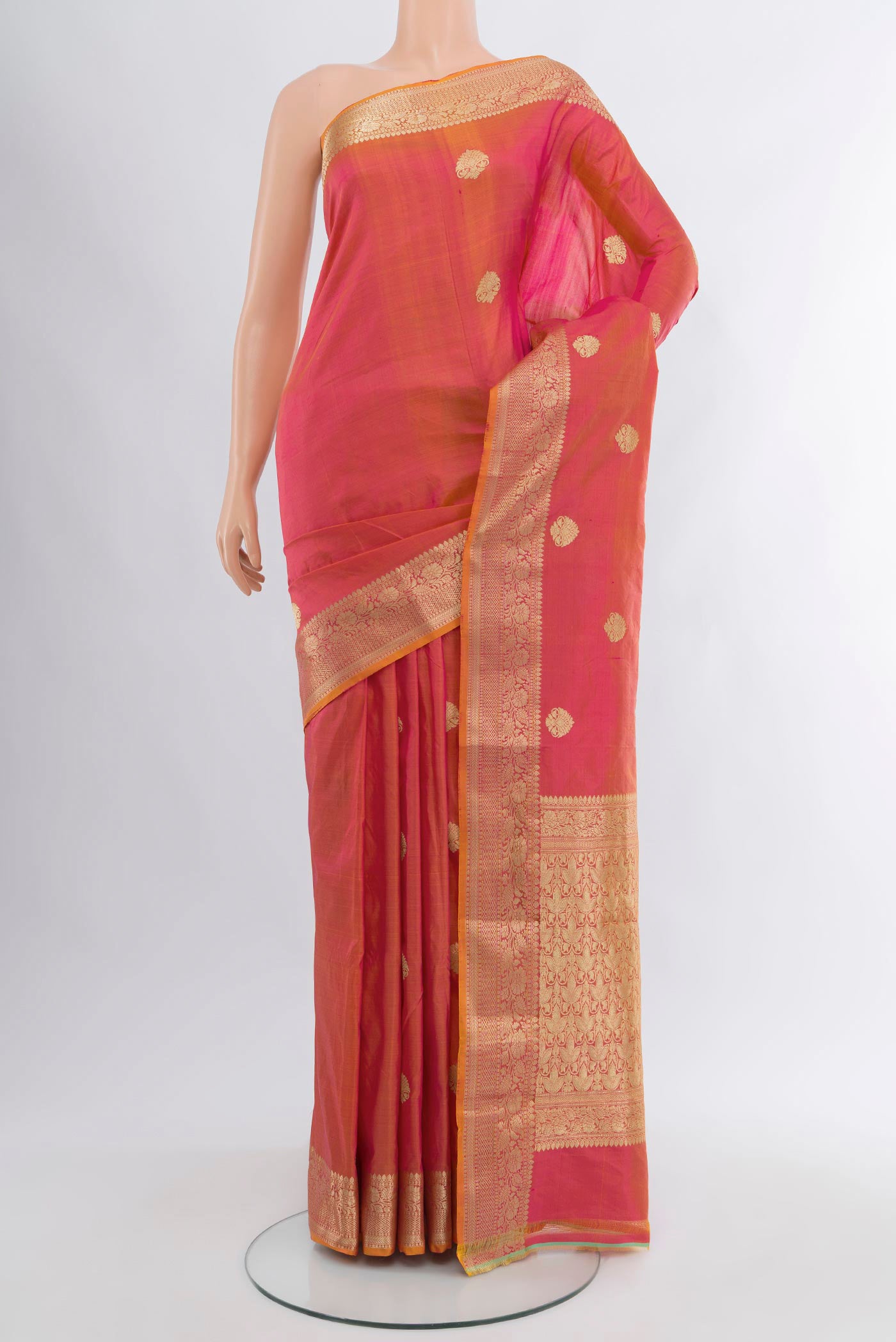 Pinkish Yellow Banarasi Katan Silk Saree with Zari Butta on the body and Zari Border.  displayed on a mannequin