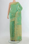 Pure Silk Light Green Banarasi Katan Saree with Zari Butta on the body and Zari Border.  displayed on a mannequin