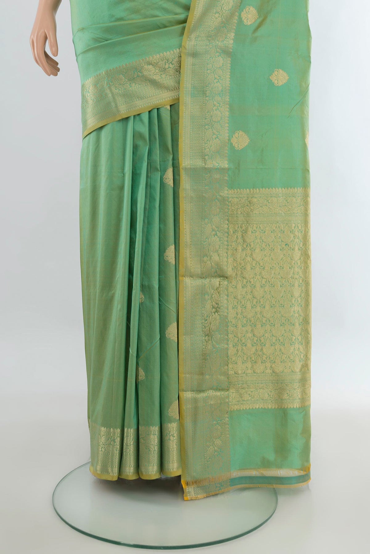 Pleats and pallu of Pure Silk Light Green Banarasi Katan Saree with Zari Butta on the body and Zari Border. 